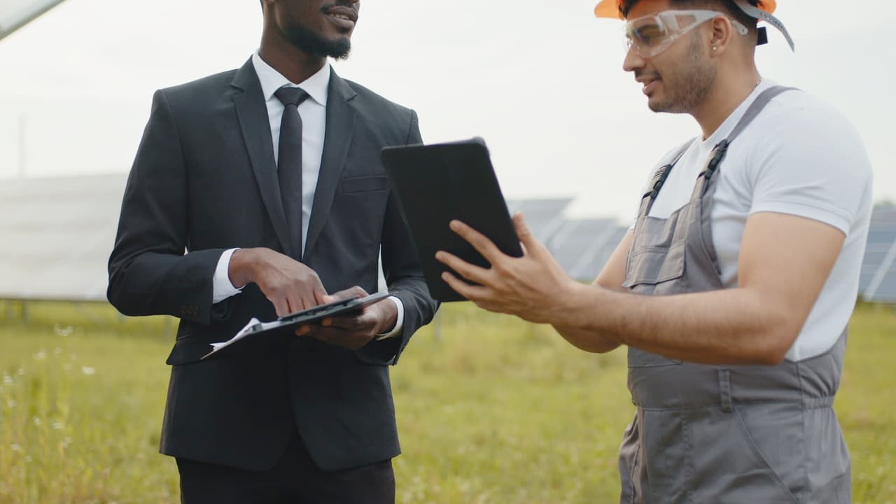 An advisor and a solar technician reviewing results on-site at Green Subsidy